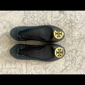 Black Tory Burch flats with gold toe.